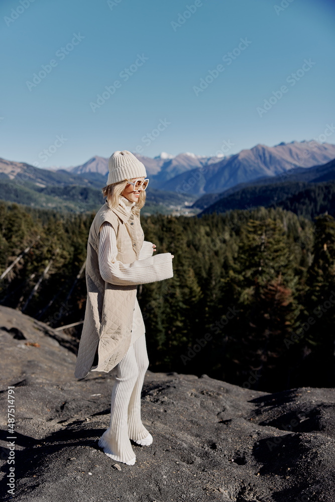 woman standing on the top of the mountain forest lifestyle
