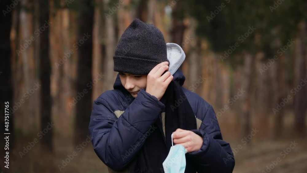 Self isolation during coronavirus quarantine boy putt on protective medical face mask in forest. Stop dangerous covid infection Self isolation during coronavirus quarantine boy putt on protective medical face mask in forest. Stop dangerous covid infection