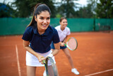 Portrait of fit happy women playing tennis together. People sport concept