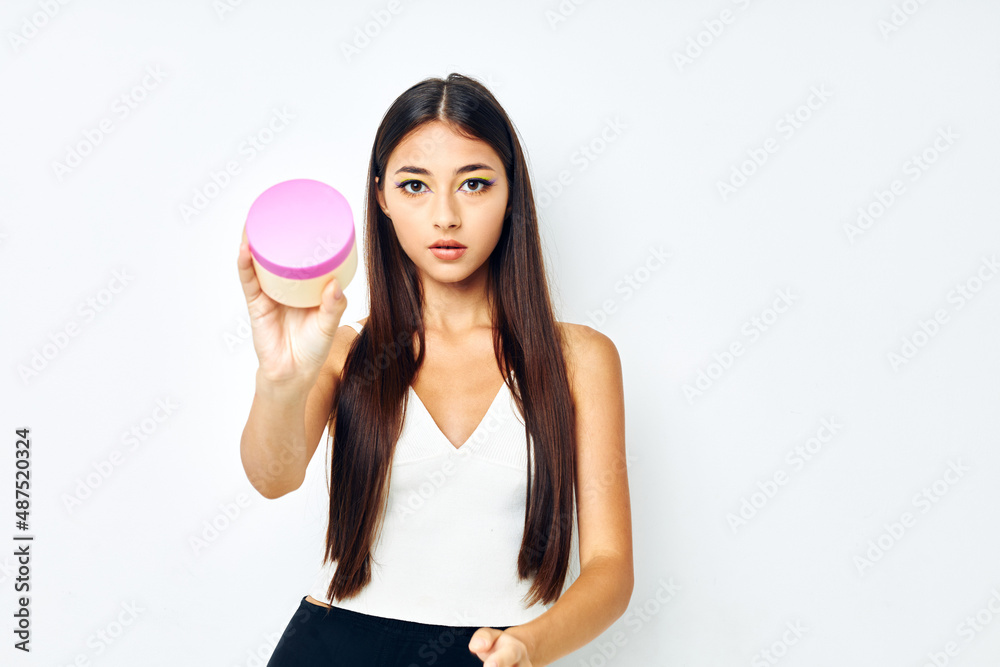 portrait pretty woman posing cream jar cosmetics isolated background unaltered portrait pretty woman posing cream jar cosmetics isolated background unaltered