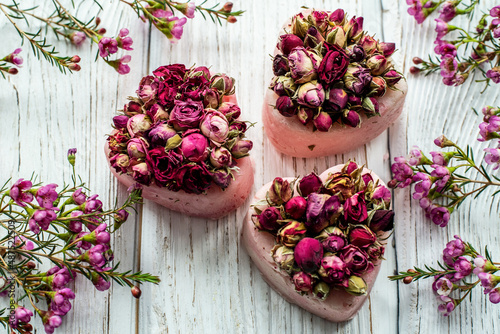 handmade soap with dry rose impurities on a white background