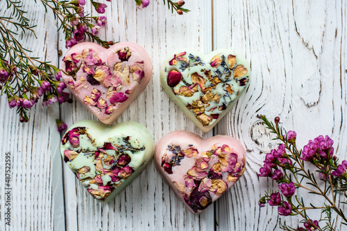 handmade soap with dry rose impurities on a white background