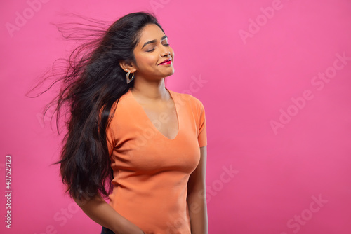 Portrait of a beautiful woman posing with closed eyes and blowing hair © IndiaPix
