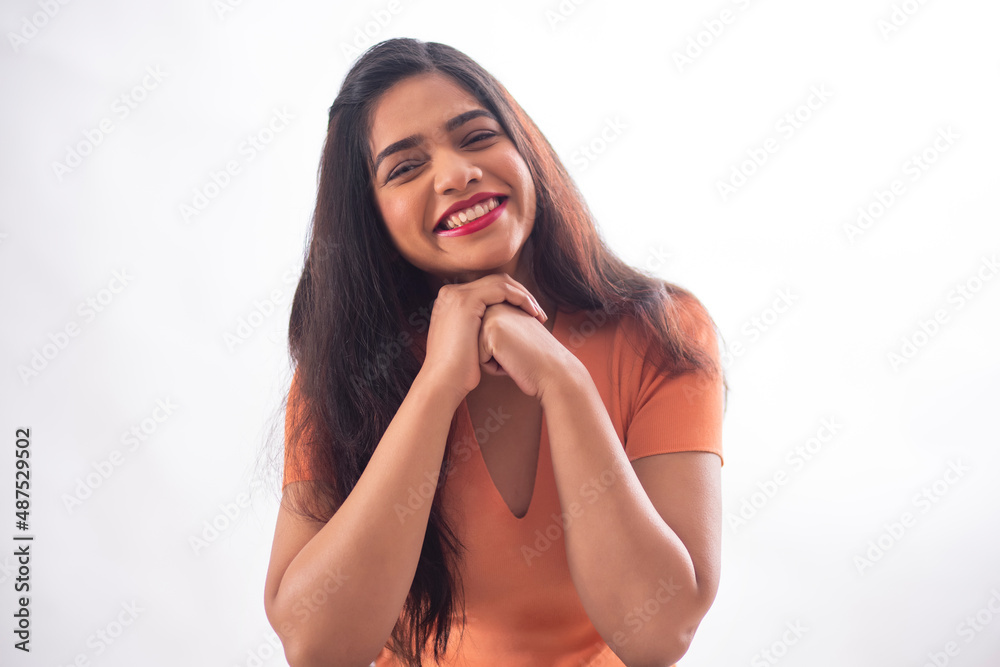 portrait of a beautiful woman looking at camera and smiling with resting chin on hands portrait of a beautiful woman looking at camera and smiling with resting chin on hands