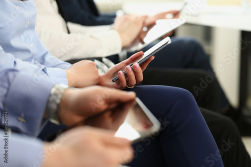 People using mobile phones on meeting, modern gadgets in work