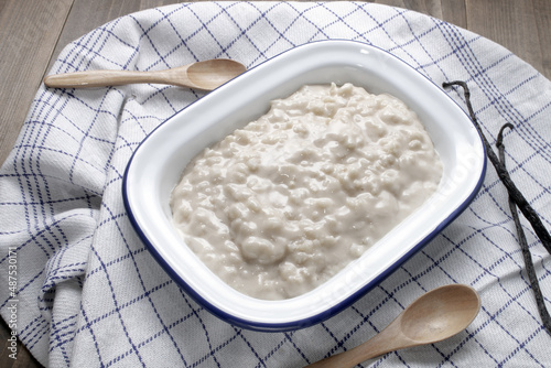 homemade vanilla rice pudding in a white enamel bowl