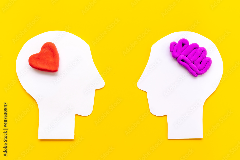 Brain and heart. Logic and emotion communication concept with two paper heads Brain and heart. Logic and emotion communication concept with two paper heads