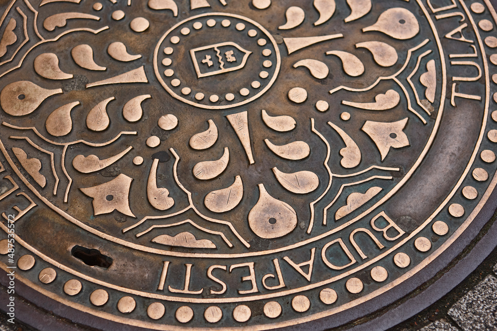 Urban manhole cover in Budapest town main street. Hungary