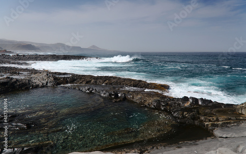 Gran Canaria, north coast, rockpools around Puertillo de Banaderos area protected from the 
ocean waves by volcanic rock barrier photo