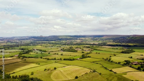 Drone timelapse over patchwork fields in North York Moors with clouds photo