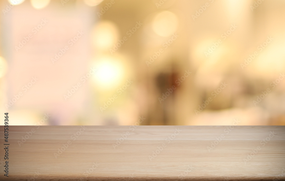 Empty wooden table in front of abstract blurred background of coffee shop . can be used for display or montage your products.Mock up for display of product Empty wooden table in front of abstract blurred background of coffee shop . can be used for display or montage your products.Mock up for display of product
