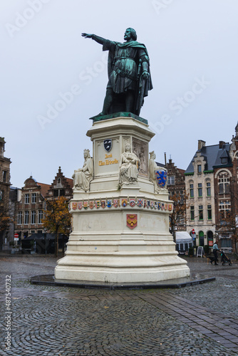 Statue in a square in Ghent, with a cloudy day.