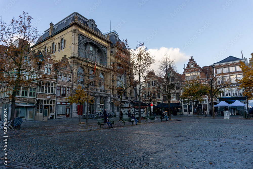 Typical buildings of Ghent seen from a cobbled square, on a cloudy and rainy day