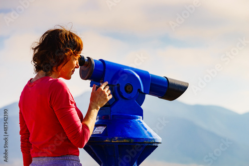 Woman using tourist binoculars, Cabo de Gata, Spain photo