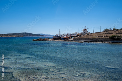 Greece. Koufonisi island  Cyclades. Windmill  shipyard for wooden fishing boat  sea  blue sky.