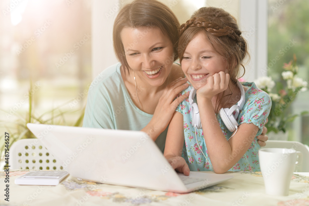 mother and daughter using laptop mother and daughter using laptop