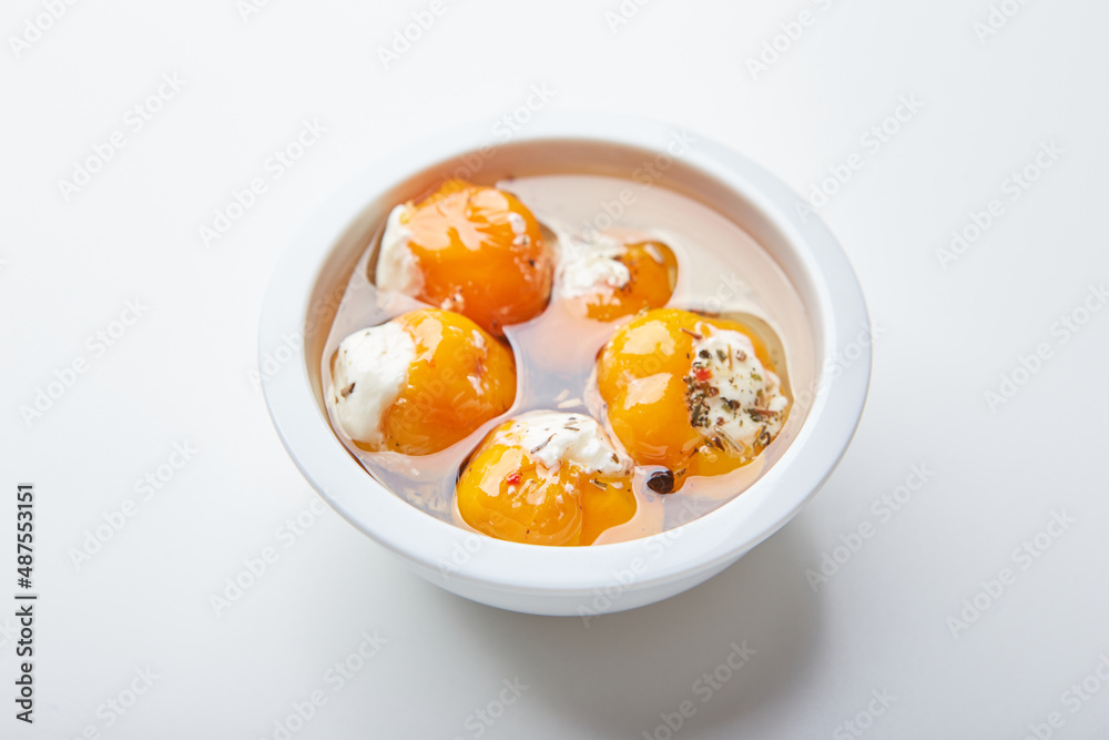 Pickled hot yellow tiny cherry peppers stuffed with soft cream or ricotta cheese. Delicious snack Pickled hot yellow tiny cherry peppers stuffed with soft cream or ricotta cheese. Delicious snack