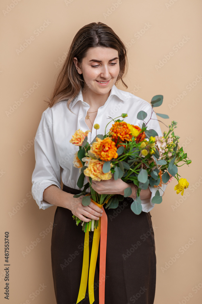 people and floral design concept - portrait of happy smiling woman holding bunch of flowers over beige background people and floral design concept - portrait of happy smiling woman holding bunch of flowers over beige background