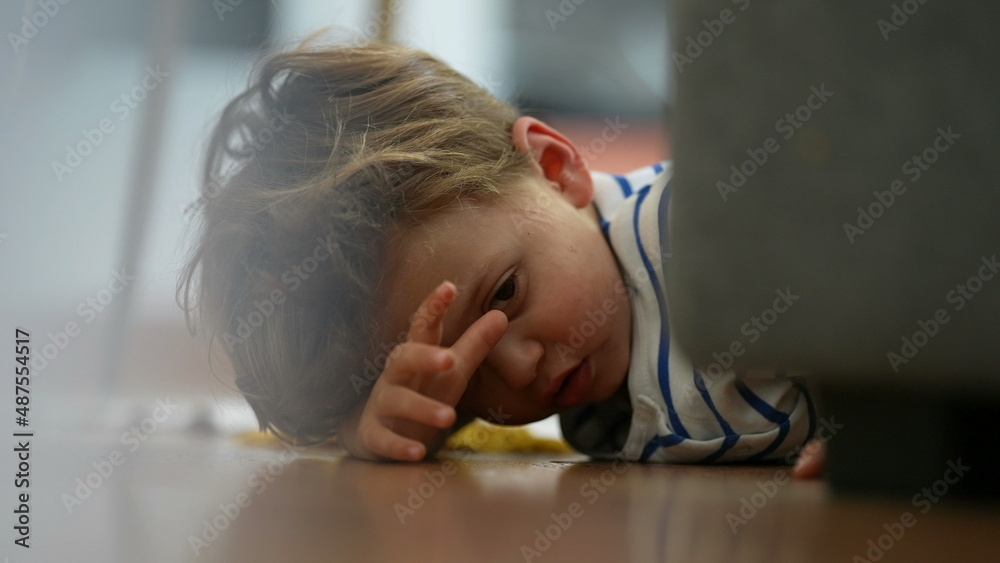 Angry little boy lying on floor feeling upset and boredom at home Angry little boy lying on floor feeling upset and boredom at home