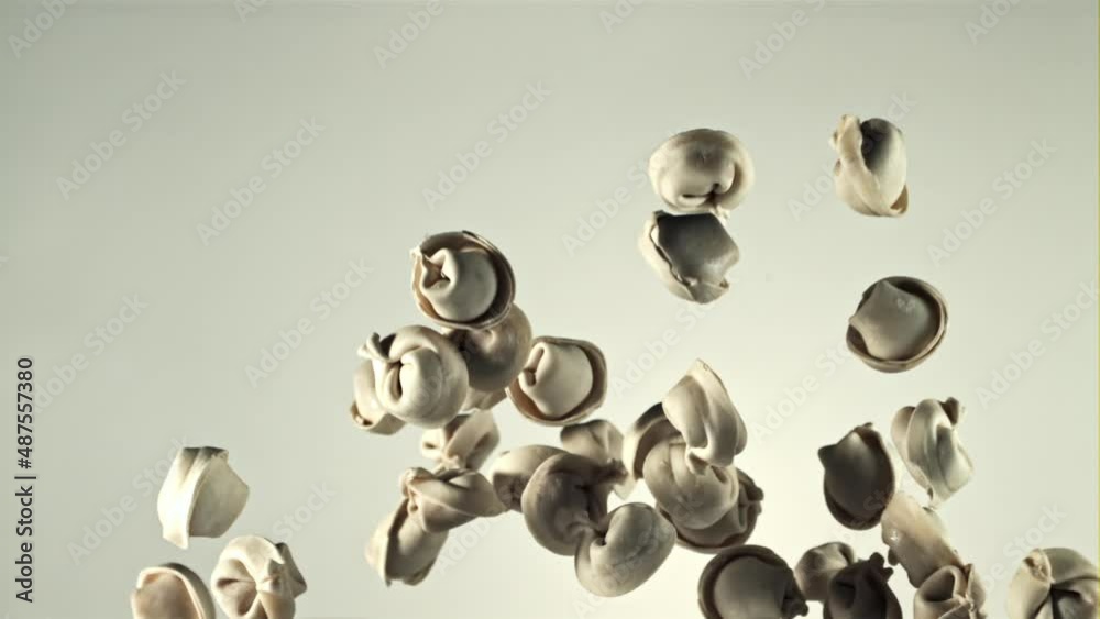 Raw homemade dumplings go up and down. On a white background.Filmed on a high-speed camera at 1000 fps. High quality FullHD footage Raw homemade dumplings go up and down. On a white background.Filmed on a high-speed camera at 1000 fps. High quality FullHD footage