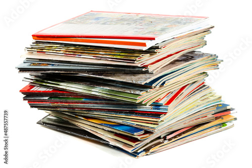 A messy pile of old, colorful magazines on light background. © krysek