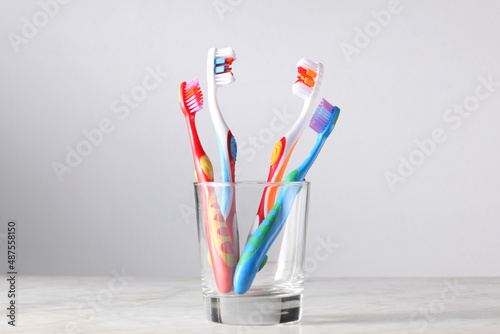 four toottbrushes  for parents and children in  a glass with copy space for your text