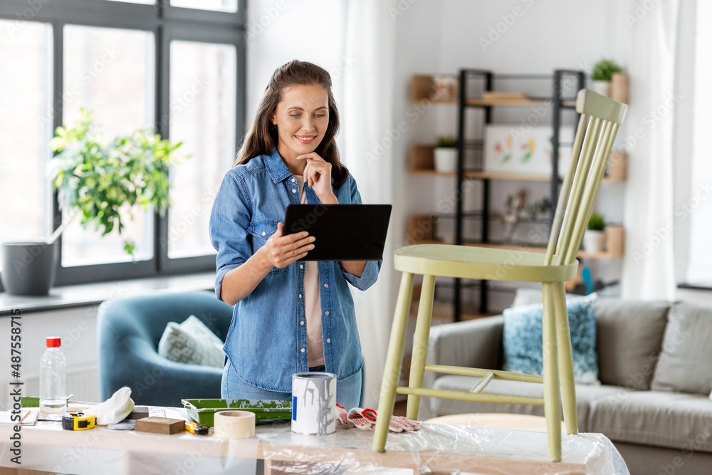 furniture restoration, diy and home improvement concept - happy woman with tablet pc computer preparing old wooden chair for renovation furniture restoration, diy and home improvement concept - happy woman with tablet pc computer preparing old wooden chair for renovation