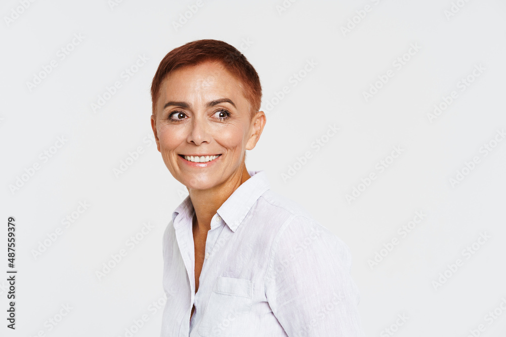 Ginger senior woman with short hair smiling and looking aside Ginger senior woman with short hair smiling and looking aside