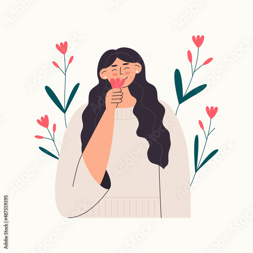 Smiling woman smelling flower