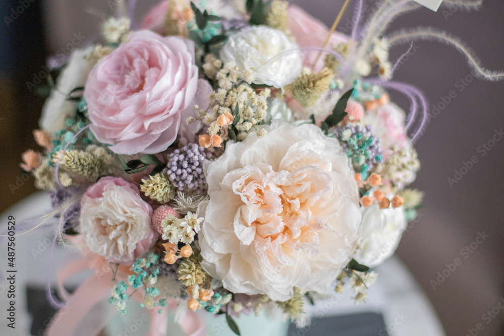 Beautiful spring flowers in box of tender peonies, roses and Gypsophila flowers. Preserved flowers for womens. Beautiful spring flowers in box of tender peonies, roses and Gypsophila flowers. Preserved flowers for womens.