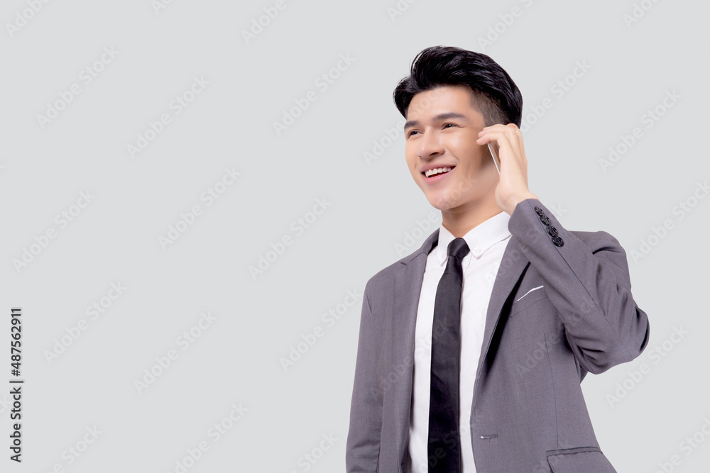 Young asian business man in suit talking on mobile phone isolated on white background, businessman speaking and listening smartphone with conversation, male holding cell phone, communication concept. Young asian business man in suit talking on mobile phone isolated on white background, businessman speaking and listening smartphone with conversation, male holding cell phone, communication concept.