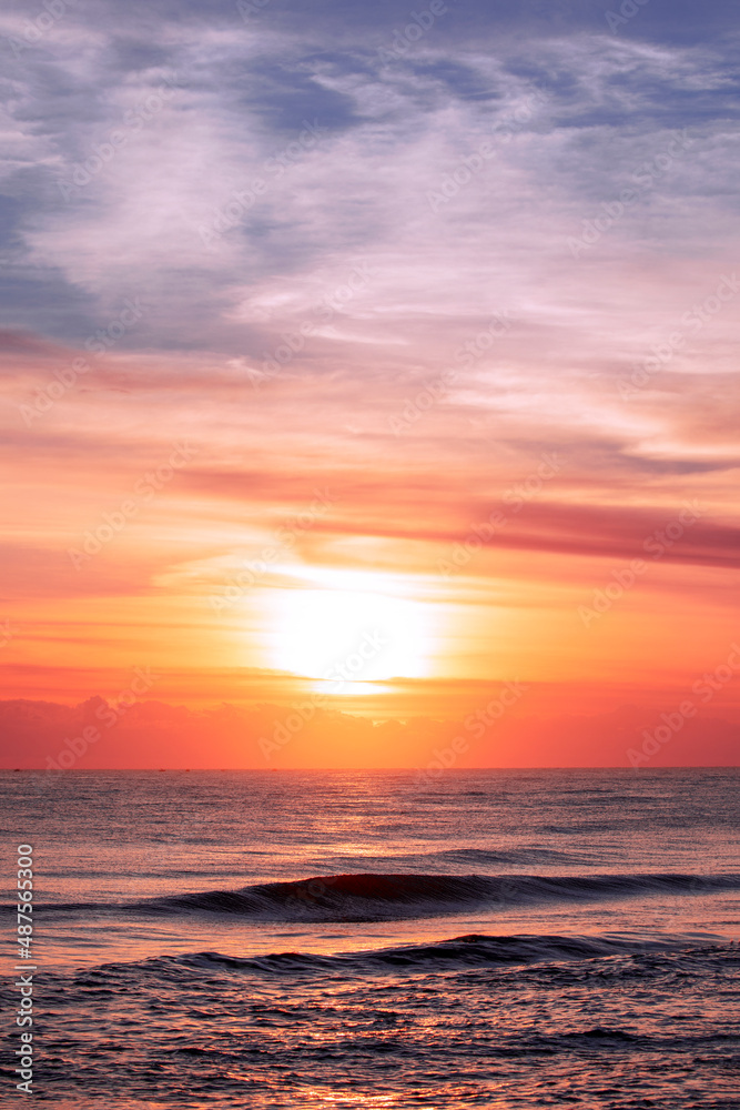 Orange lit sunrise skies over ocean. Gold Coast, Australia
