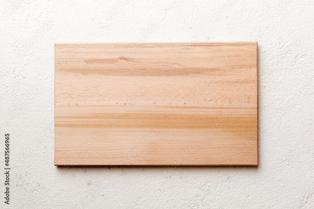 Top view of wooden cutting board on cement background. Empty space for your design Top view of wooden cutting board on cement background. Empty space for your design