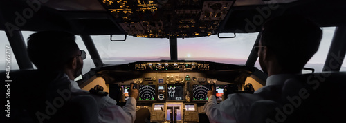 back view of professionals piloting airplane, banner.