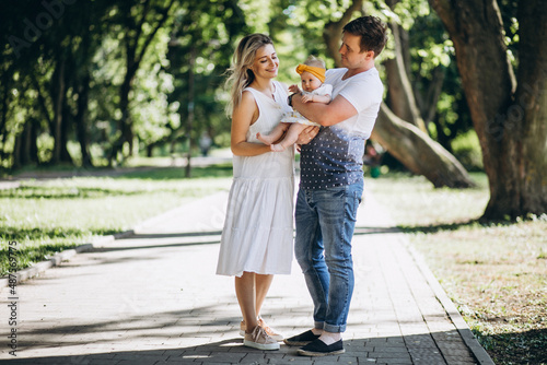 Young couple with their baby daughter in park