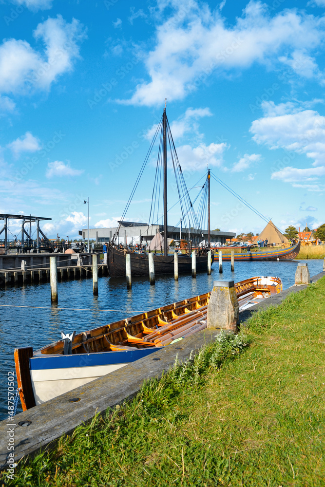 Boat and ships in the Roskilde harbor, Denmark. Sunny day on a summer vacation. Boat and ships in the Roskilde harbor, Denmark. Sunny day on a summer vacation.
