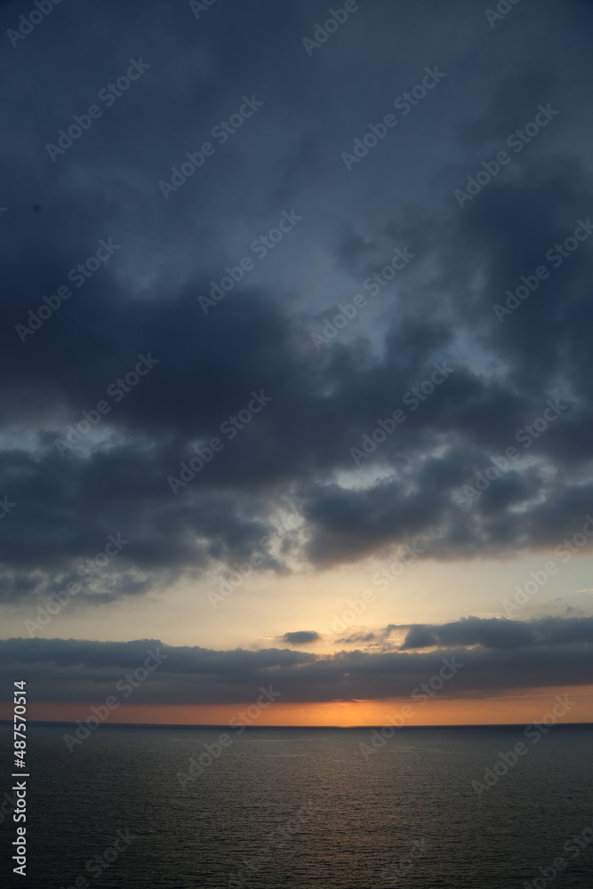 Sunset over the Mediterranean sea with clear sky. Sun over the water with cloudy atmospheric moods