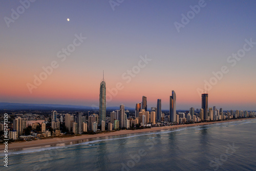 Moon setting at dusk over Gold Coast cityscape