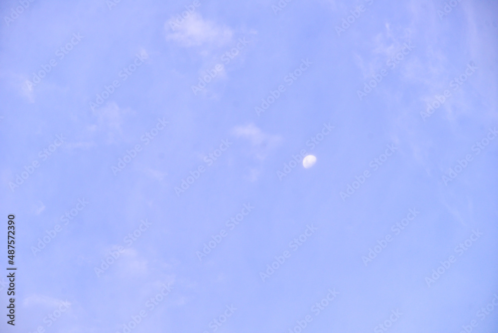 blue sky with clouds and waning moon blue sky with clouds and waning moon