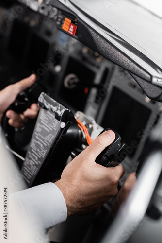 close up view of pilot using yoke in airplane. © LIGHTFIELD STUDIOS