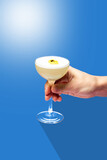 cocktail minimalism. cocktail on a colored background. cocktail in hand