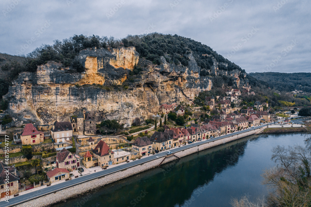 Aerial view of an ancient medieval French village along the river and mountain cliff,  La Roque-Gageac, France