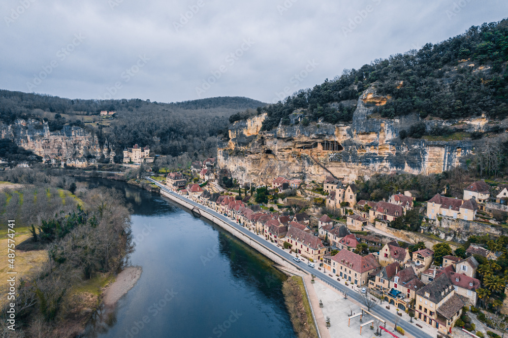 Aerial view of an ancient medieval French village along the river and mountain cliff,  La Roque-Gageac, France