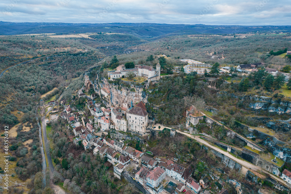 Aerial view of an ancient french village and its castle on cliff, Rocamadour at dusk
