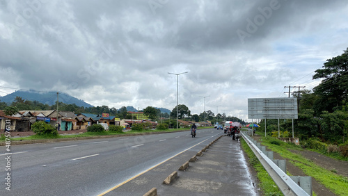 On the streets of Arusha. Green hills  roads  houses and transport of Tanzania.