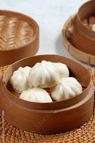 baozi or bapao,bakpao-Chinese steamed buns,served in bamboo steamer.white background 