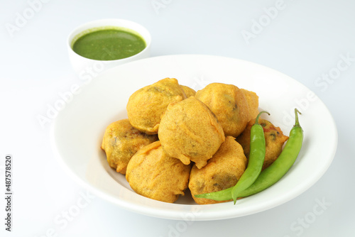 Indian snack aloo vada or bonda made from potato with coconut chutney. Indian snacks Aloo Bonda vada, pakoda, pakora.Paneer bonda indian snack, Served with tomato sauce placed 