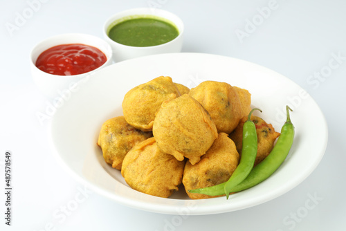 Indian snack aloo vada or bonda made from potato with coconut chutney. Indian snacks Aloo Bonda vada, pakoda, pakora.Paneer bonda indian snack, Served with tomato sauce placed 