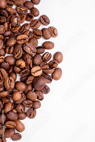 fragrant beans from the coffee tree in medium roast lie on a white background with a place for text