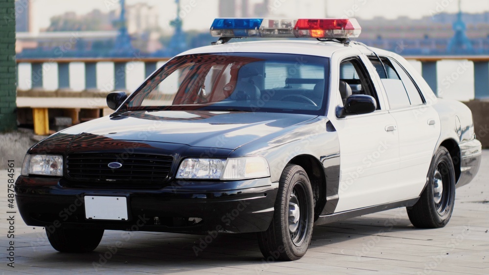 American police car with flares on against the backdrop of downtown American police car with flares on against the backdrop of downtown